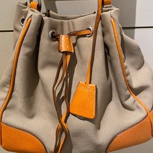 Prada bucket bag in beige and orange.